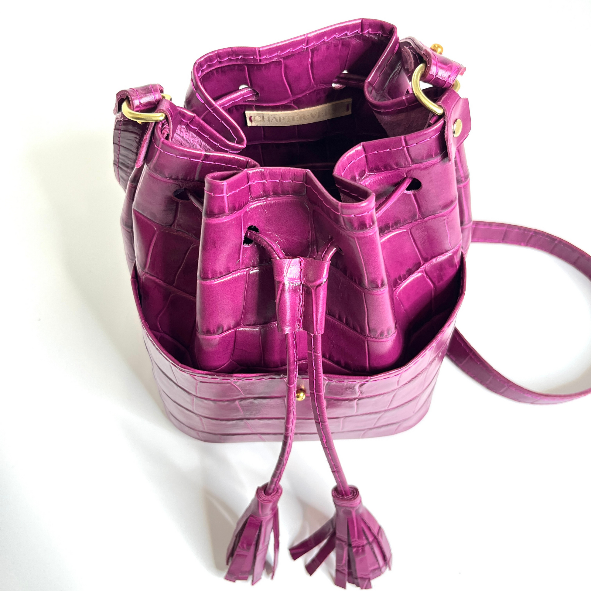 Displaying top portion of bucket bag with the drawstring taute